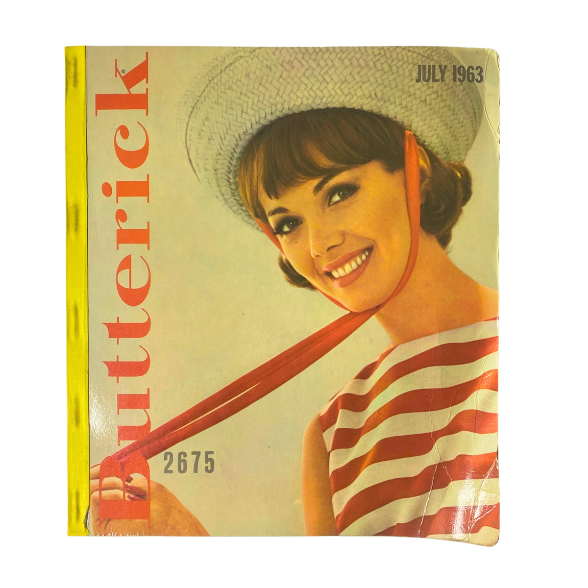 1963 Butterick June Catalog cover featuring a smiling woman in a striped dress and straw hat, promoting vintage sewing patterns for women and teens.