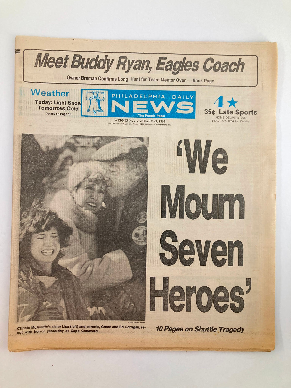 Philadelphia Daily News Tabloid from January 29, 1986, featuring the headline 'We Mourn Seven Heroes' along with an image related to Christa McAuliffe, Ed, and Grace, commemorating the shuttle tragedy with weather updates and sports news.
