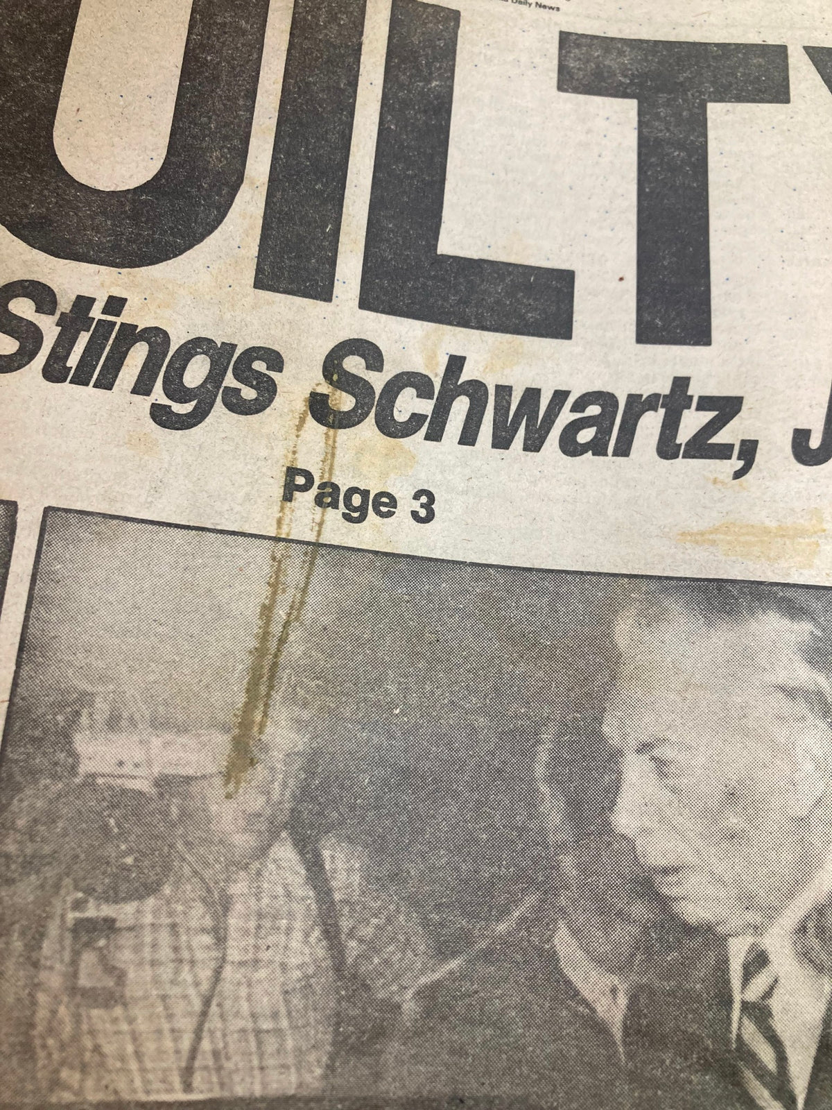 Close-up of Philadelphia Daily News tabloid from September 17, 1980, showing the 'GUILTY' headline about Schwartz and Jannotti with visible stains and wear.
