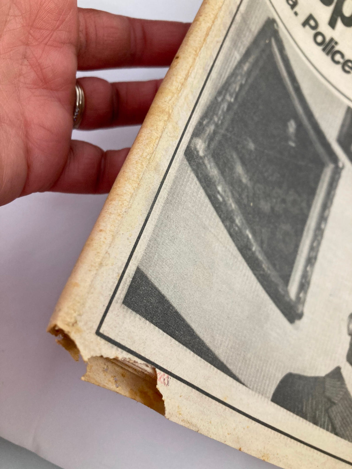 Close-up of the edge of the November 5, 1982 Philadelphia Daily News Tabloid, highlighting wear and tear on the edges with a focus on the article about W. Wilson Goode's resignation.