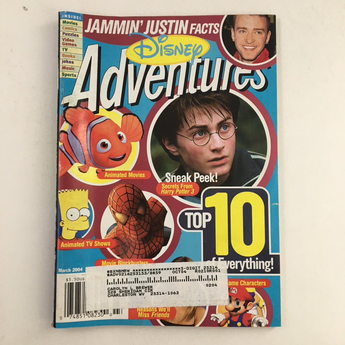 Disney Adventures Magazine March 2004 featuring Justin Timberlake and Daniel Radcliffe on the cover. The magazine showcases vibrant graphics, including animated characters like a fish and Spider-Man, offering a peek into the pop culture of the early 2000s.