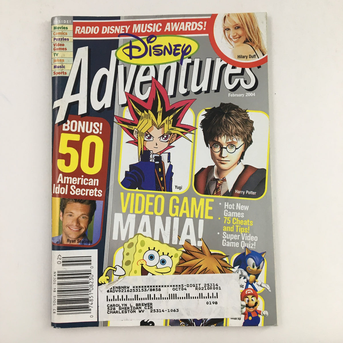 Cover of Disney Adventures Magazine February 2004 showcasing Hilary Duff and Harry Potter, featuring illustrations of Yugi and video game content, and highlights American Idol secrets.