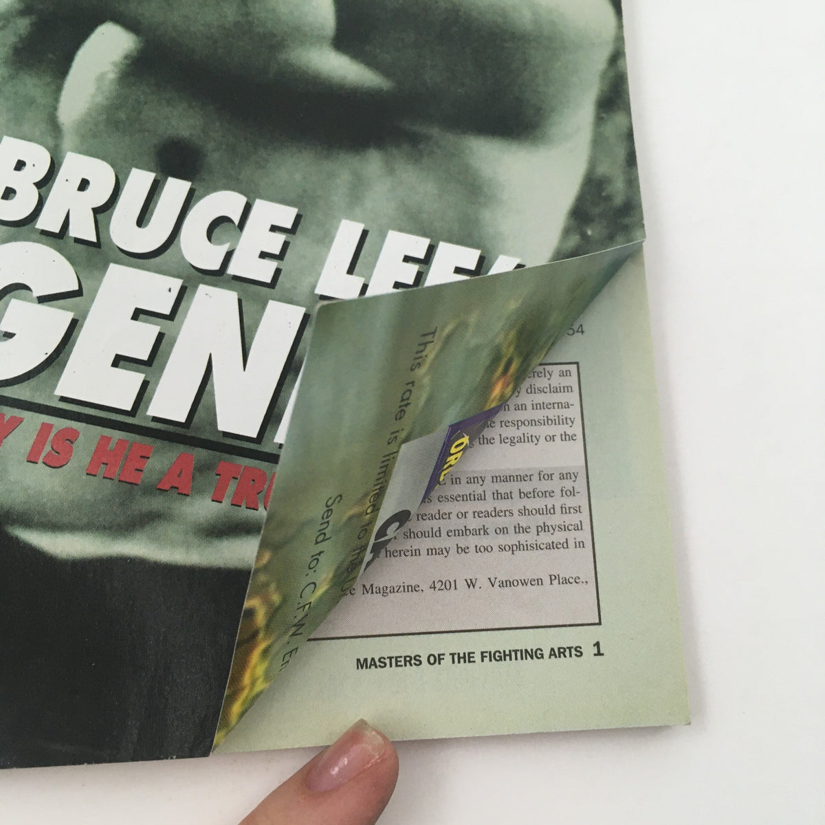 Close-up view of a partially turned page of Masters of the Fighting Arts Magazine September 2000, revealing a glimpse of the magazine's interior design and content related to martial arts.