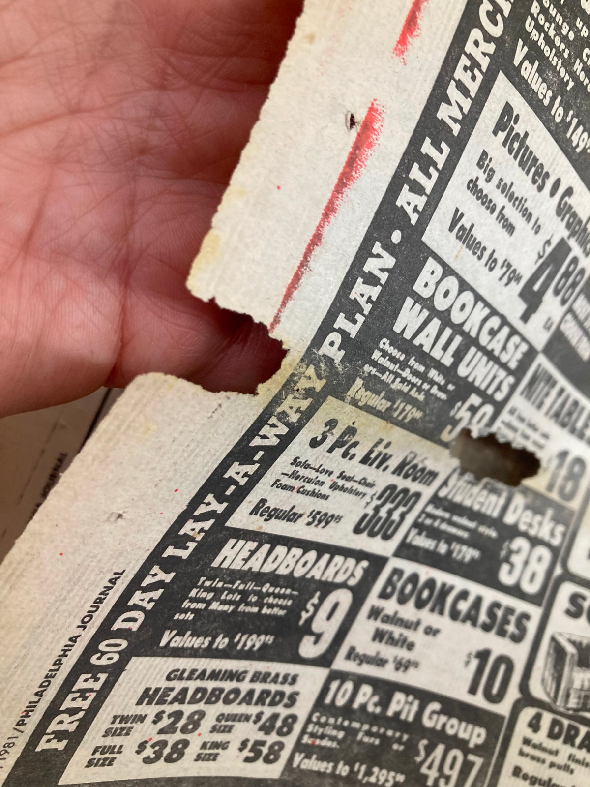Detailed view of another advertisement from the Philadelphia Journal, featuring pricing for headboards and furniture items, with visible wear and a tear.
