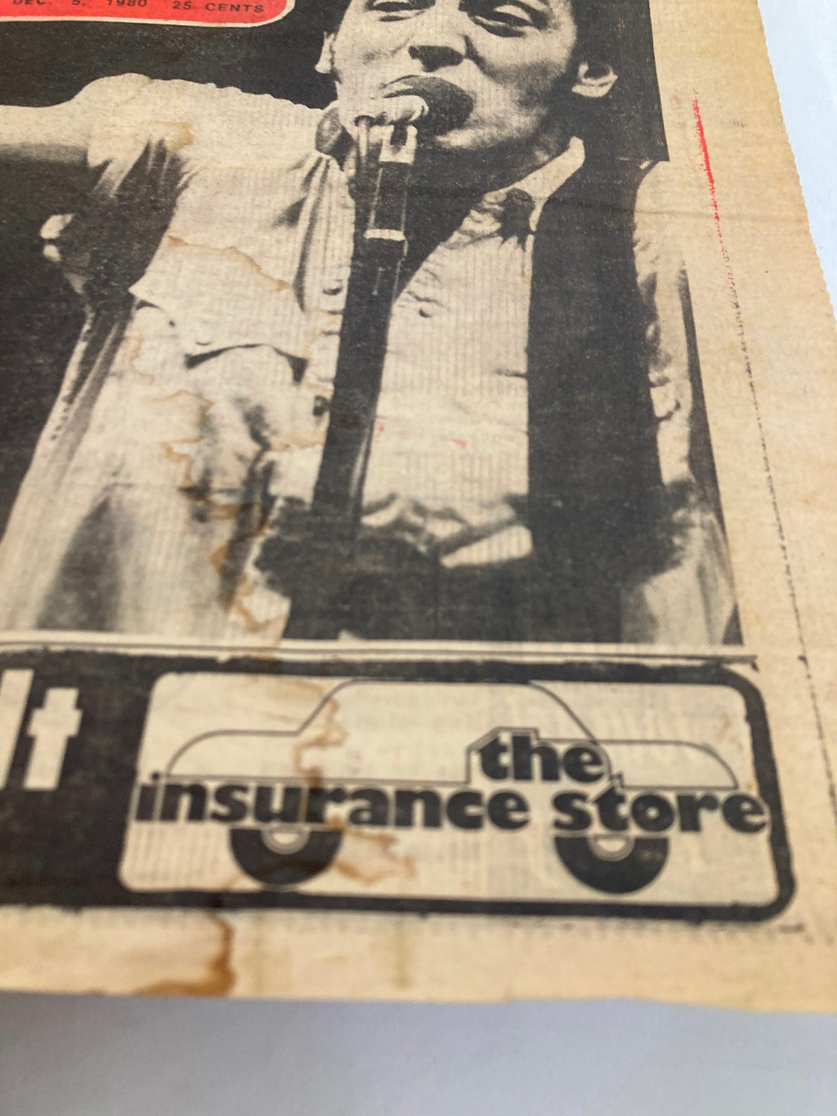 Close-up of the Philadelphia Journal cover featuring Bruce Springsteen from December 5 1980, showing a promotional ad for 'the insurance store'.