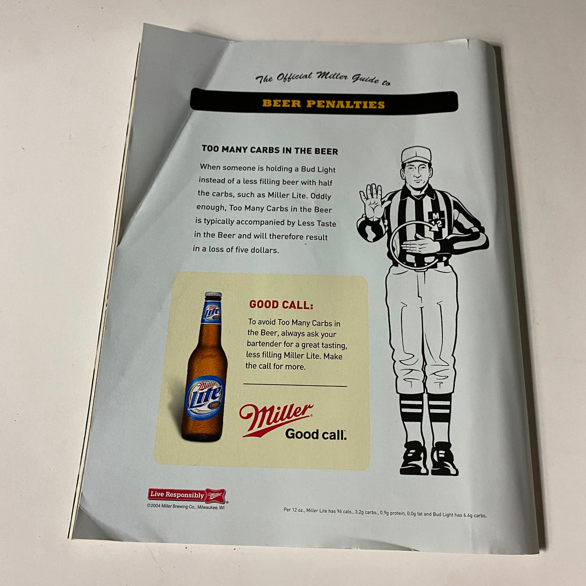 Back cover of the November 2004 Men's Fitness Magazine with a humorous advertisement about beer penalties, featuring a Miller beer bottle illustration.