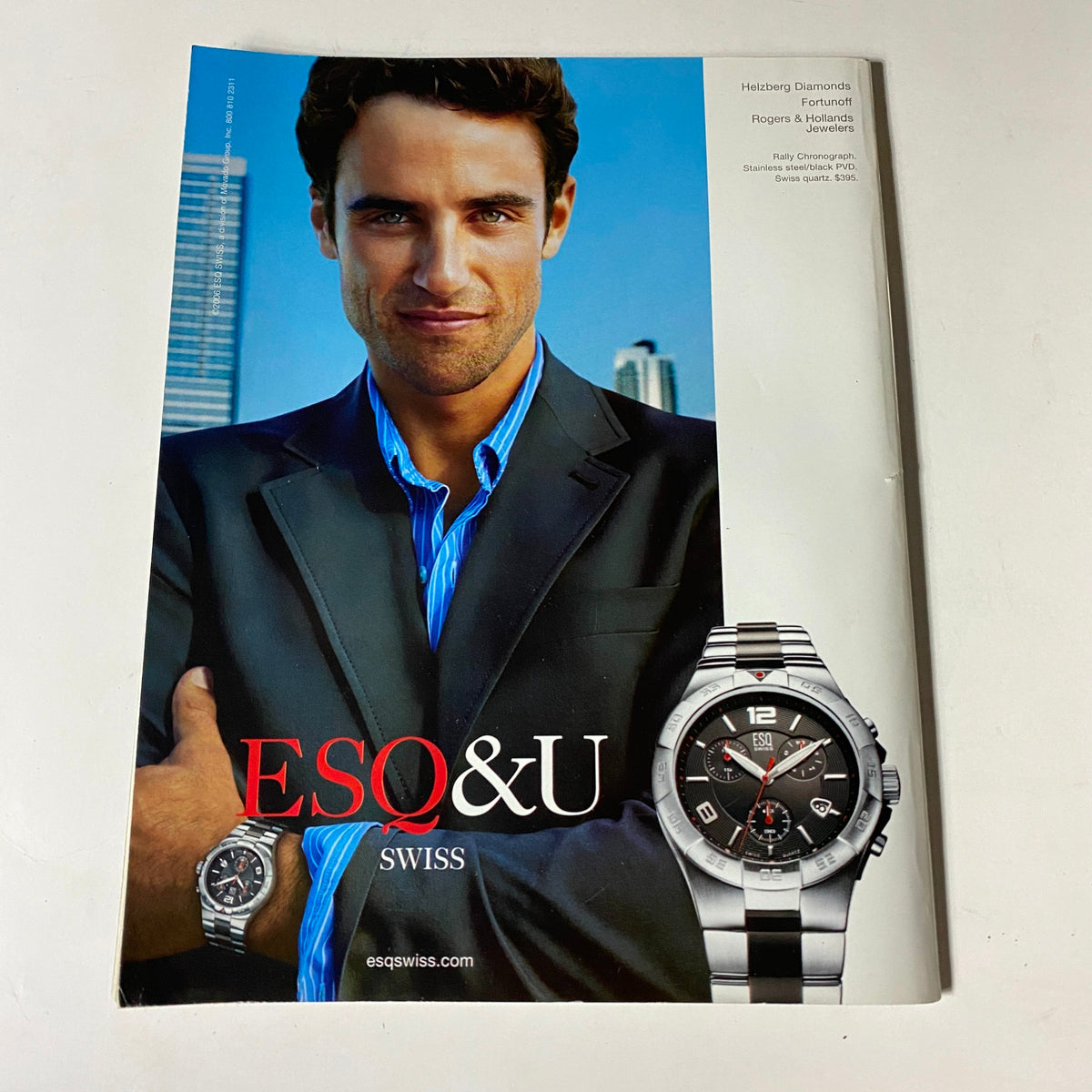 ESO&U Swiss magazine cover showcasing a well-groomed man in a suit holding a luxurious watch, ideal for style enthusiasts.