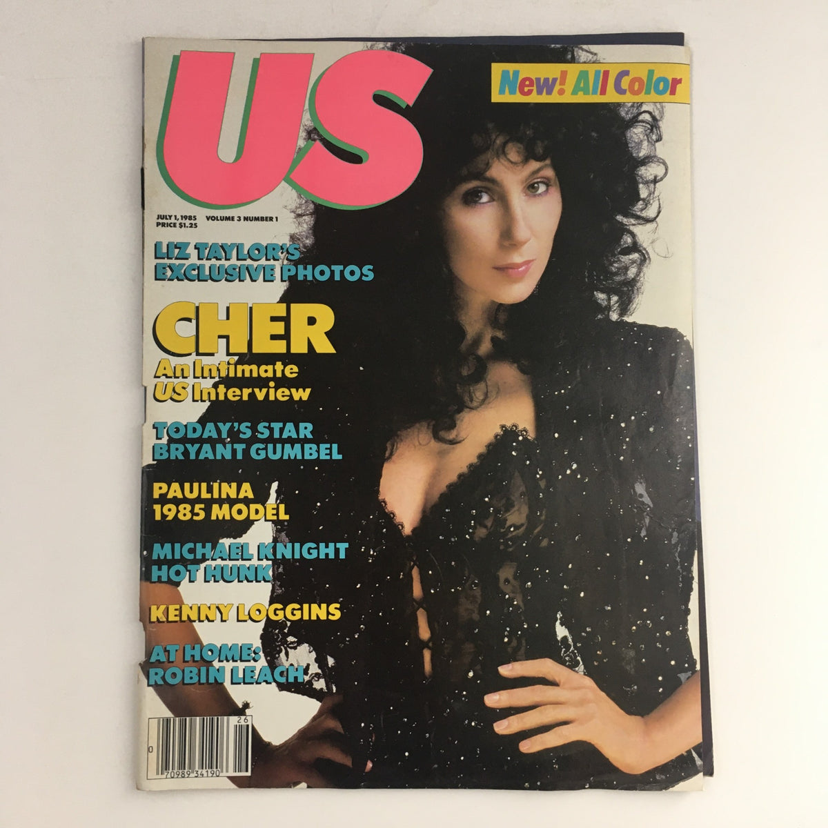 Cover of US Magazine Vol 3 #1, July 1, 1985 featuring Cher, with headline highlighting exclusive photos of Liz Taylor and other features such as Kenny Loggins and an interview with Cher.