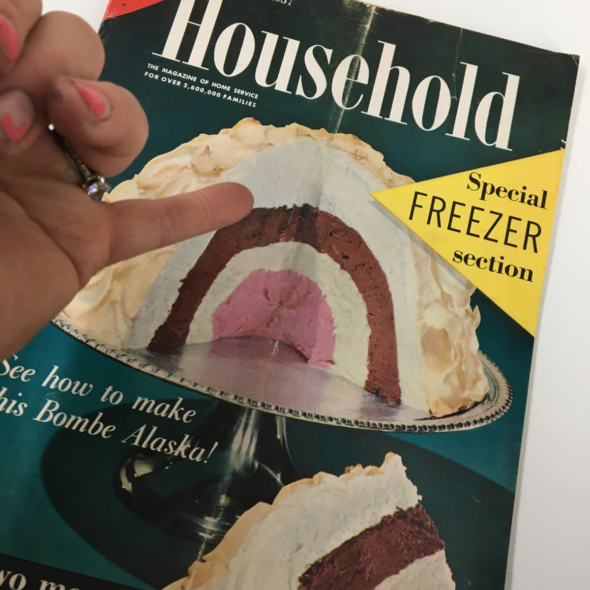 Close-up view of the VTG Household Magazine August 1957 cover with Bombe Alaska dessert and a hand gesture, highlighting the special freezer section.