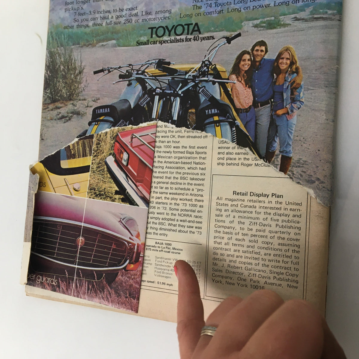 Back cover of the February 1974 Car and Driver magazine with advertisements and a vintage image of small cars and motorcycles, highlighting automotive culture from the era.