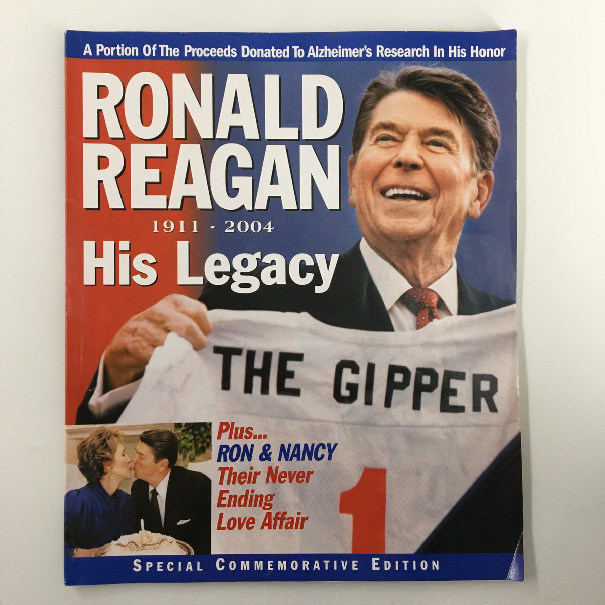Ronald Reagan 1911 - 2004 His Legacy Plus Ron & Nancy Commemorative Edition magazine cover featuring a smiling Ronald Reagan holding a jersey with 'The Gipper' written on it.