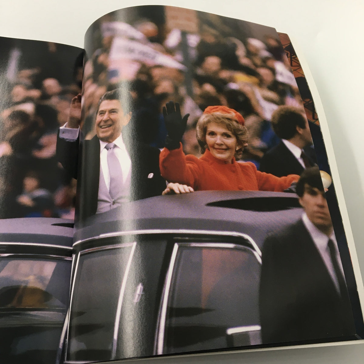 A Tribute To Reagan 1911 - 2004 capturing Ronald Reagan and Nancy Reagan waving to a crowd in a parade, symbolizing their public appeal and charisma.