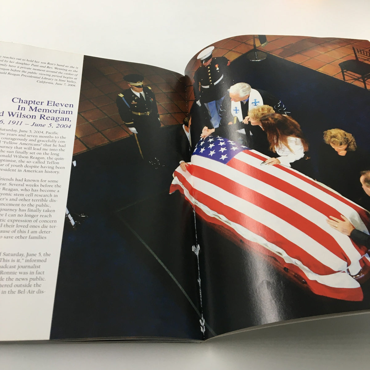 A Tribute To Reagan 1911 - 2004 depicting a solemn moment with Ronald Reagan's casket draped in an American flag, emphasizing the respect and honor during his memorial service.