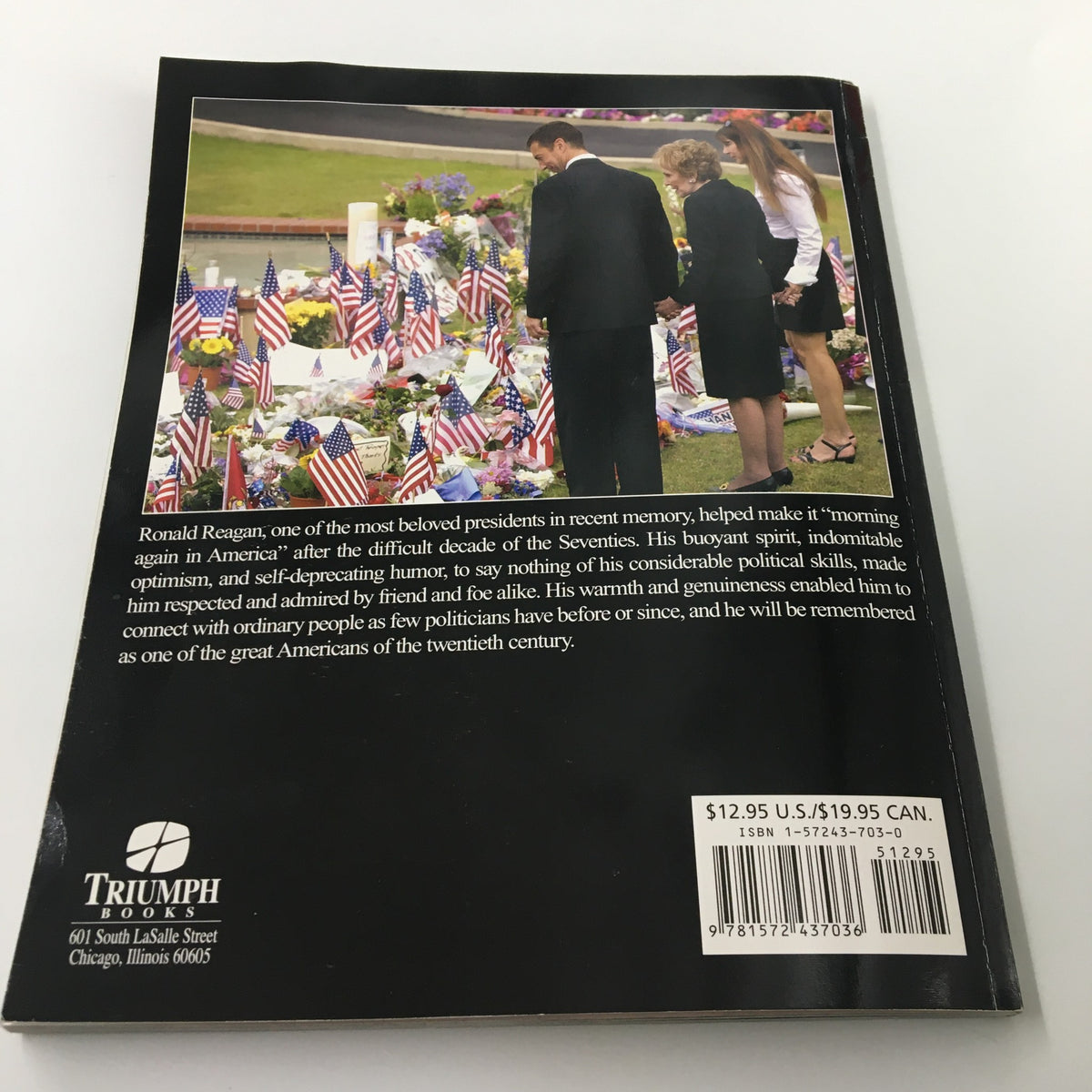 Back cover of 'A Tribute To Reagan 1911 - 2004: The Legacy of Ronald Reagan' magazine featuring historical context and a tribute to Ronald Reagan with American flags.