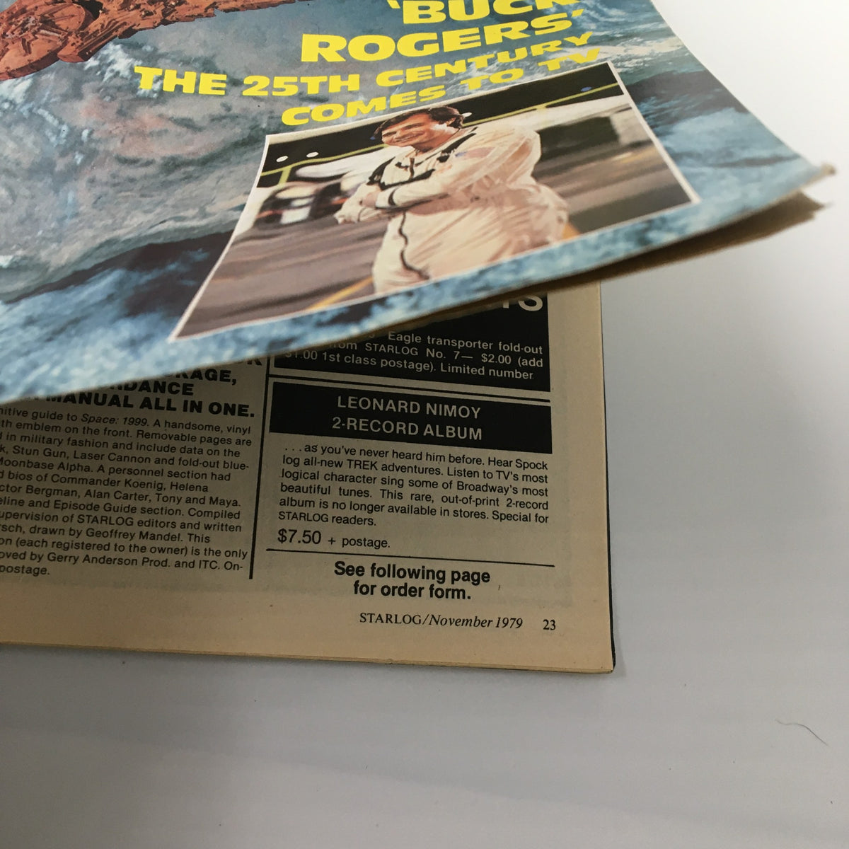 Close-up of the cover of VTG Starlog Magazine November 1979 #28 showing Buck Rogers and a feature about the 25th century. Highlights include Wonder Woman and Galactica.
