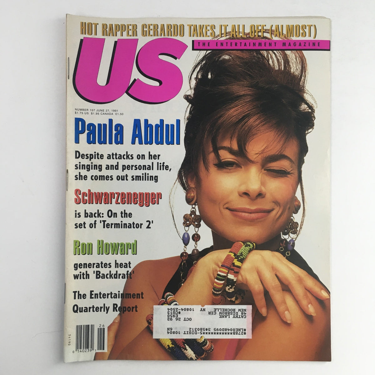 Cover of US Magazine #157 from June 27, 1991 featuring Paula Abdul with a wink, along with highlights about Arnold Schwarzenegger and Ron Howard. The issue explores the pop culture of the early 90s.
