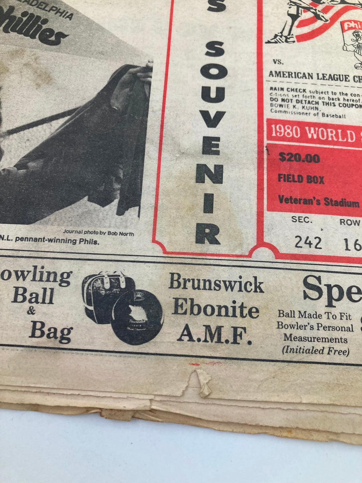 Close-up of the advertisement section from the Philadelphia Journal Tabloid, showcasing a bowling ball and bag advertisement alongside the 1980 World Series coverage.