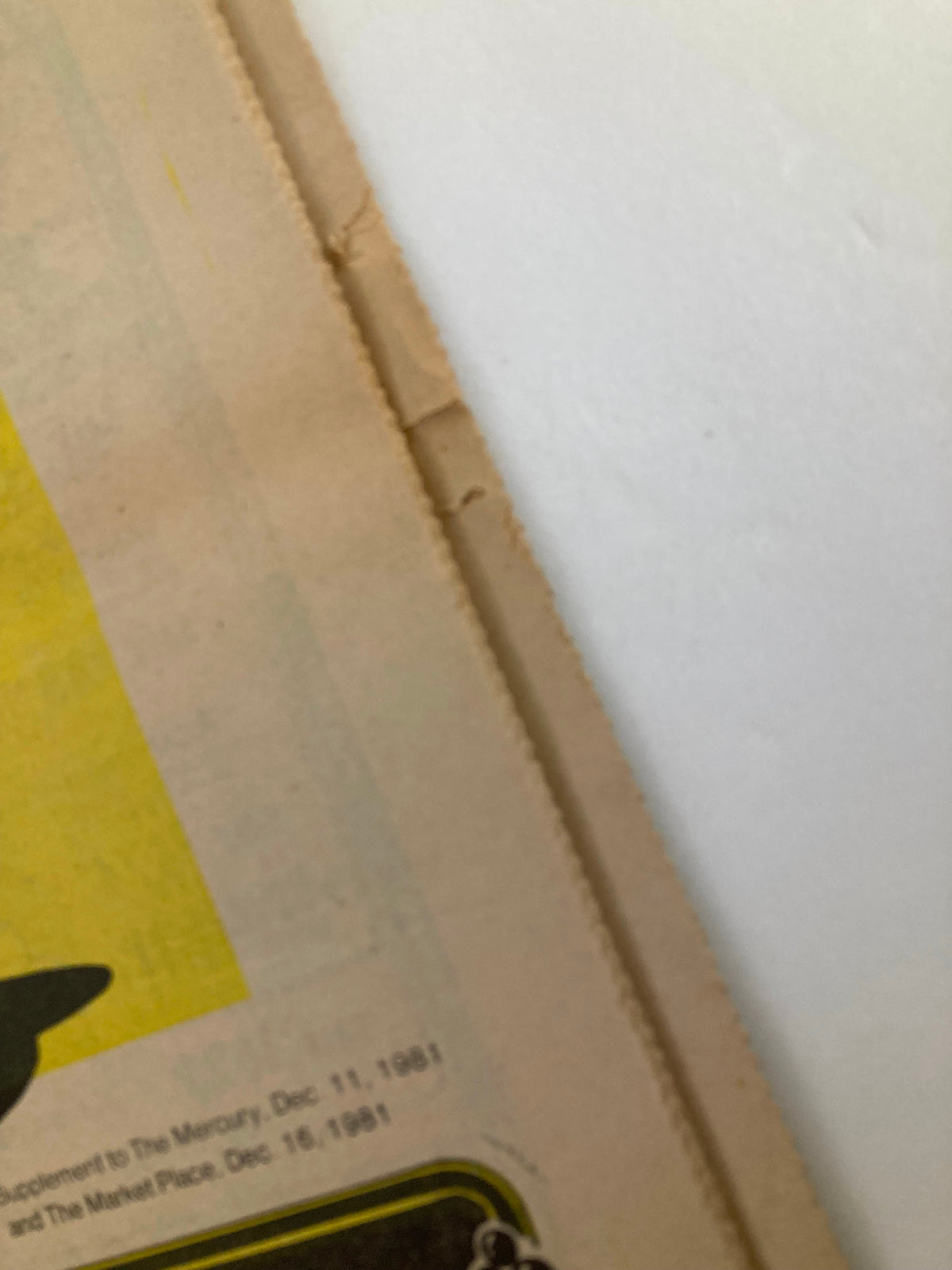 Close-up of the 1981 Last Minute Christmas Shopping Guide Supplement showing the edge and a Christmas-themed illustration, emphasizing the festive season.