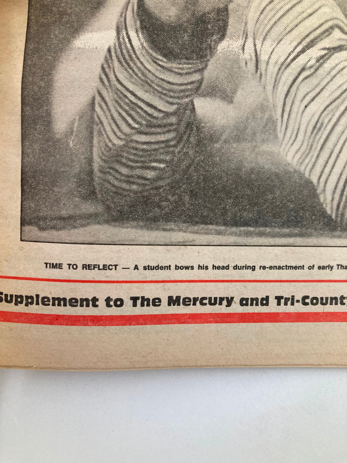 Image of The Mercury Supplementary Tabloid page with the phrase 'Time to Reflect', featuring a child bowing their head, representing a significant moment in the context of 'Chronology '86'.