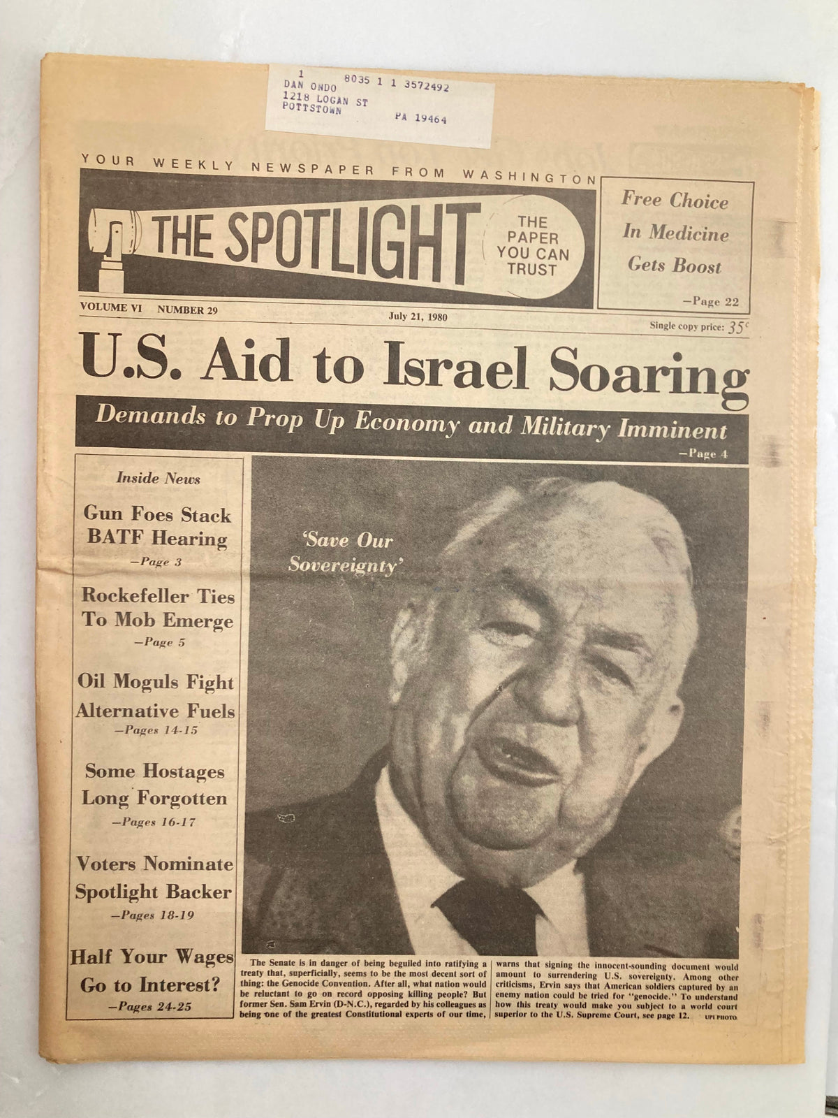 The Spotlight Newspaper July 21 1980 Vol 6 #29 featuring an article on U.S. Aid to Israel and a photograph of a smiling man addressing the camera. Good condition with minor wear and label on front, protected by plastic covering.