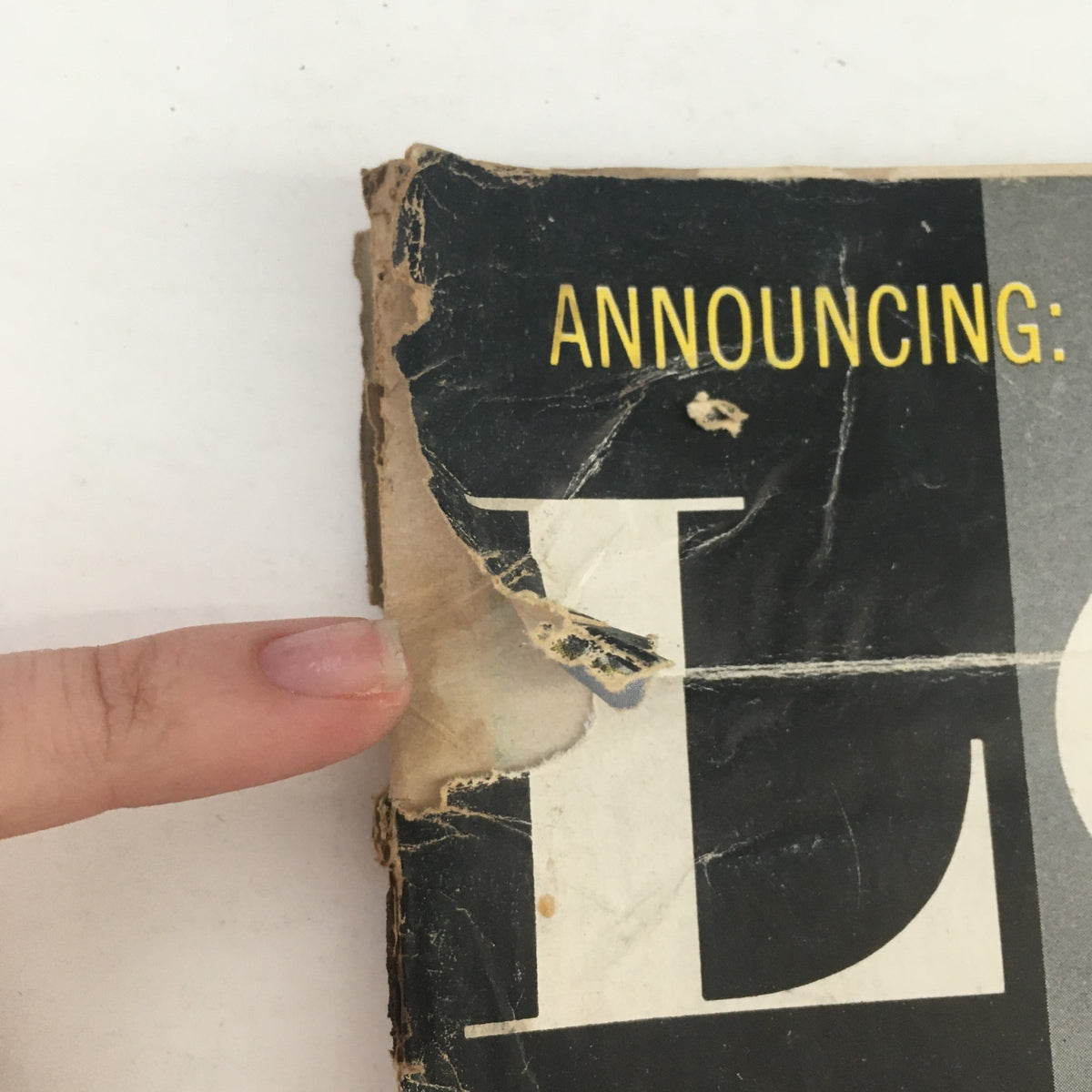 Close-up of a damaged corner on the cover of Look Magazine January 7, 1958, highlighting its vintage condition and character.