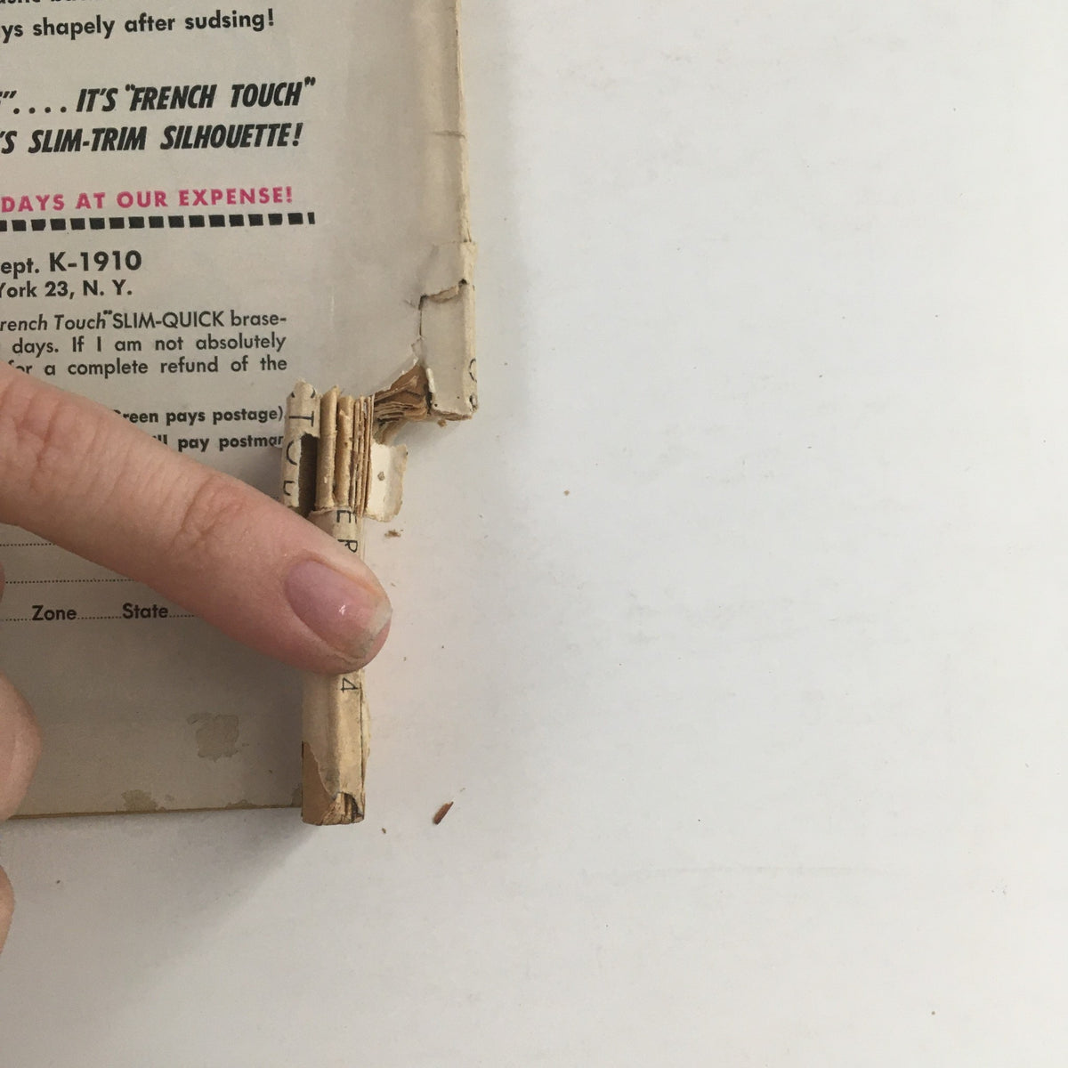 Detailed view of the binding damage on the back of the VTG Movieland October 1954 magazine, highlighting its vintage condition.