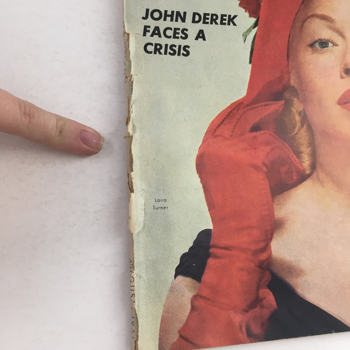Cover of VTG Movieland August 1951 featuring Lana Turner in a red hat and gloves, highlighted with the text 'JOHN DEREK FACES A CRISIS'. Original magazine in acceptable condition.