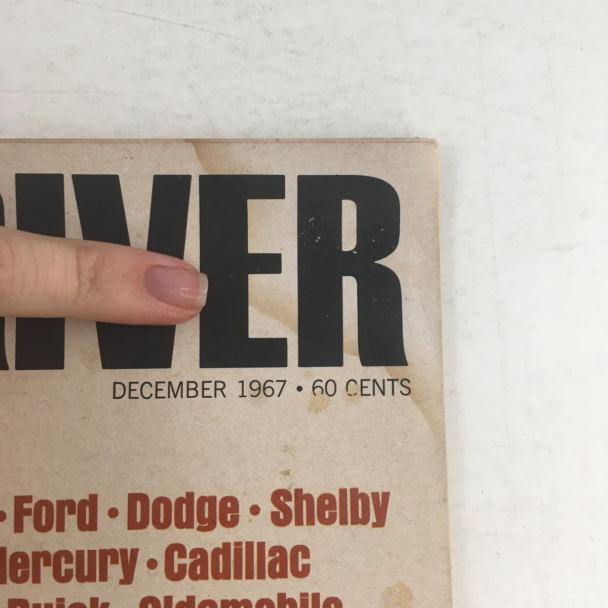 Close-up of the title 'CAR and DRIVER' on the December 1967 issue, highlighting featured brands like Chevrolet and Ford.
