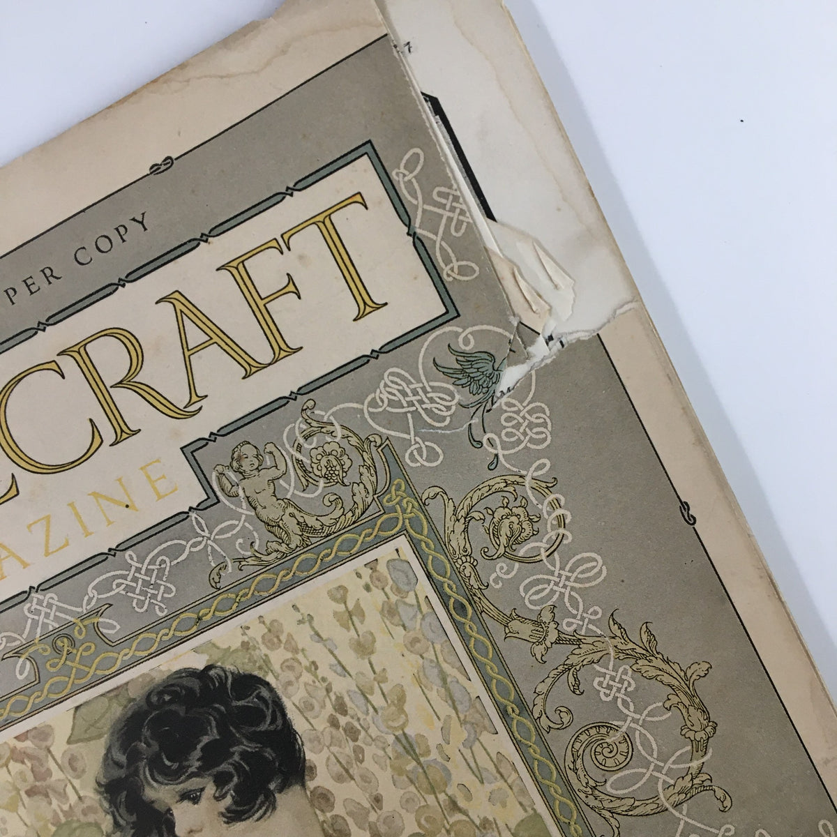 Side view of the VTG Needlecraft Magazine June 1926 cover, focusing on the magazine's title and decorative patterns, showcasing its vintage condition.