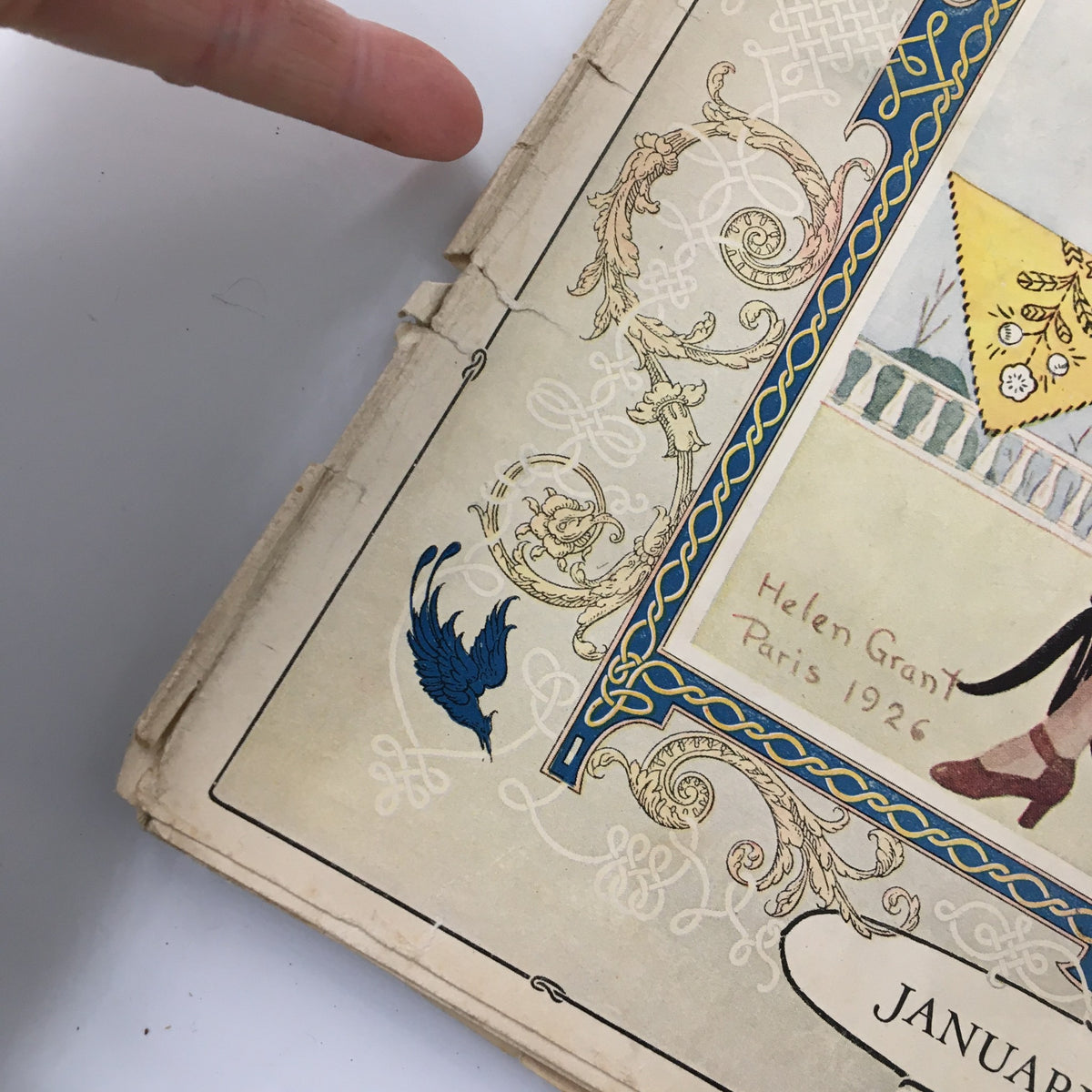 Close-up view of VTG Needlecraft Magazine January 1927, focusing on the decorative elements and the signature 'Helen Grant Paris 1926'.