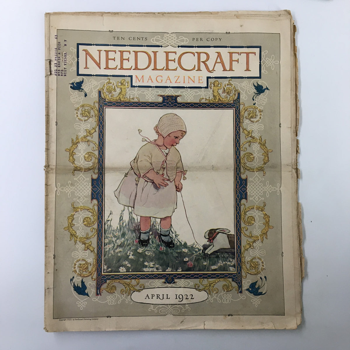 Cover of VTG Needlecraft Magazine April 1922 Vol. 13 No. 8 featuring an illustration of a child with a rabbit, embodying the Easter theme.