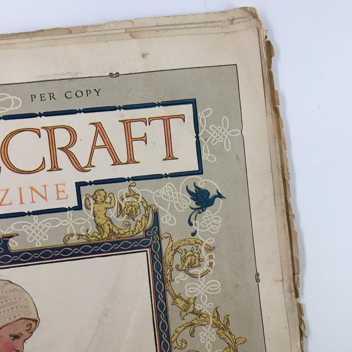 Detailed view of the VTG Needlecraft Magazine April 1922 title with vibrant colors and charming embellishments.