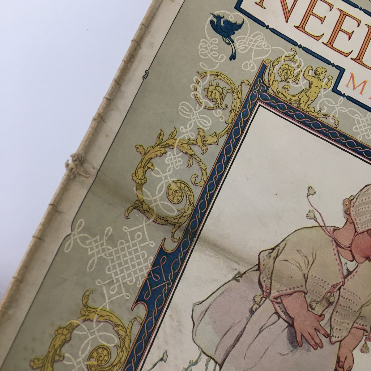 Illustration from the VTG Needlecraft Magazine April 1922 showcasing a vintage baby design and decorative borders.