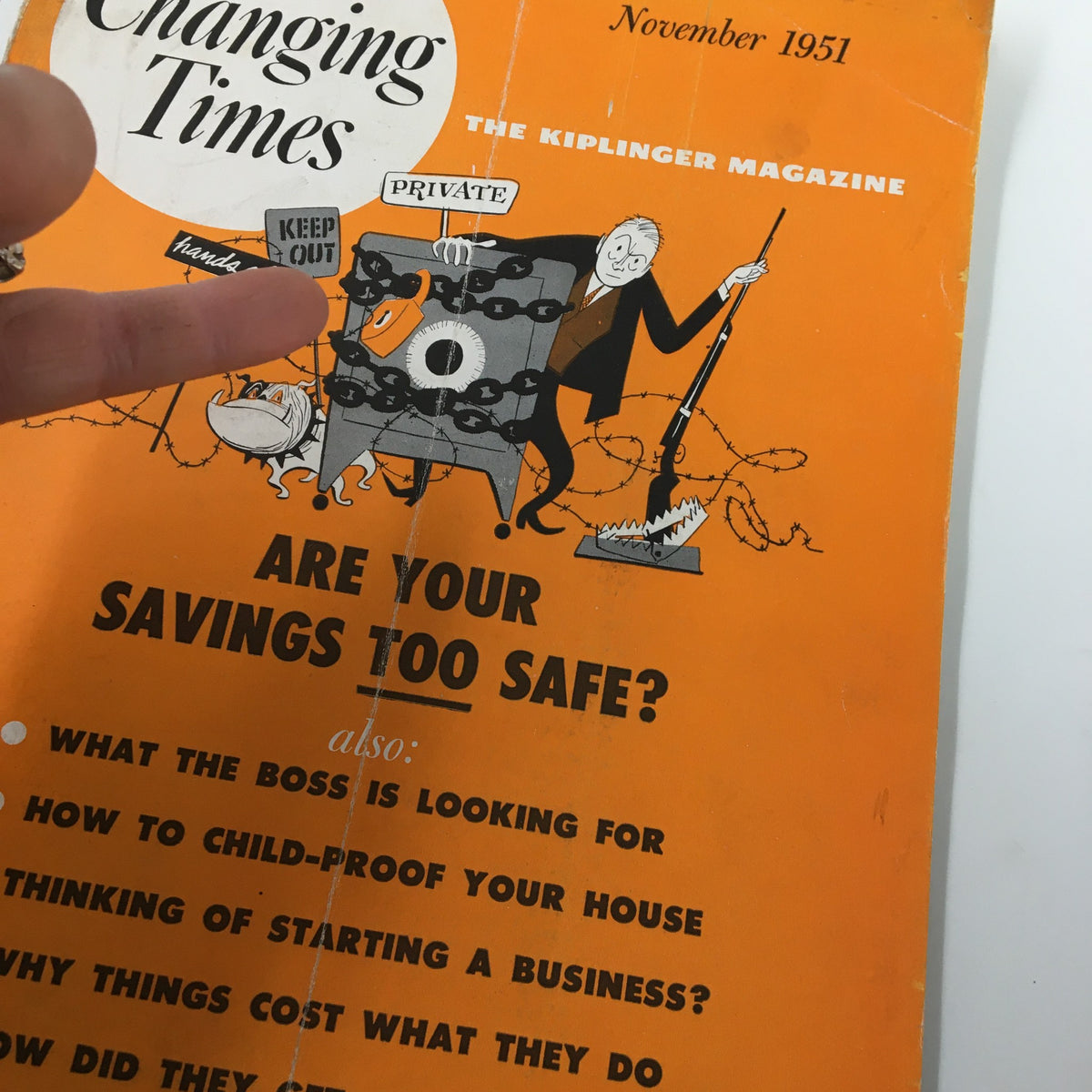 Close-up of the VTG Changing Times Magazine November 1951 cover showing the secure safe and featured articles including 'How to Child-Proof Your House' and 'Are Your Savings Too Safe?'.