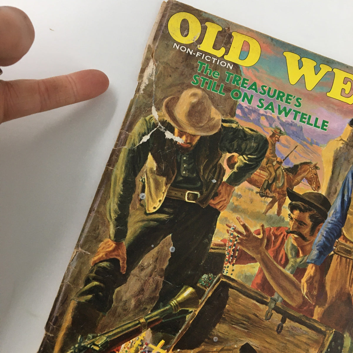 Close-up of the cover of Old West Magazine Fall 1967, highlighting the title 'The Treasure's Still On Sawtelle' and featuring characters engaged in treasure discovery.