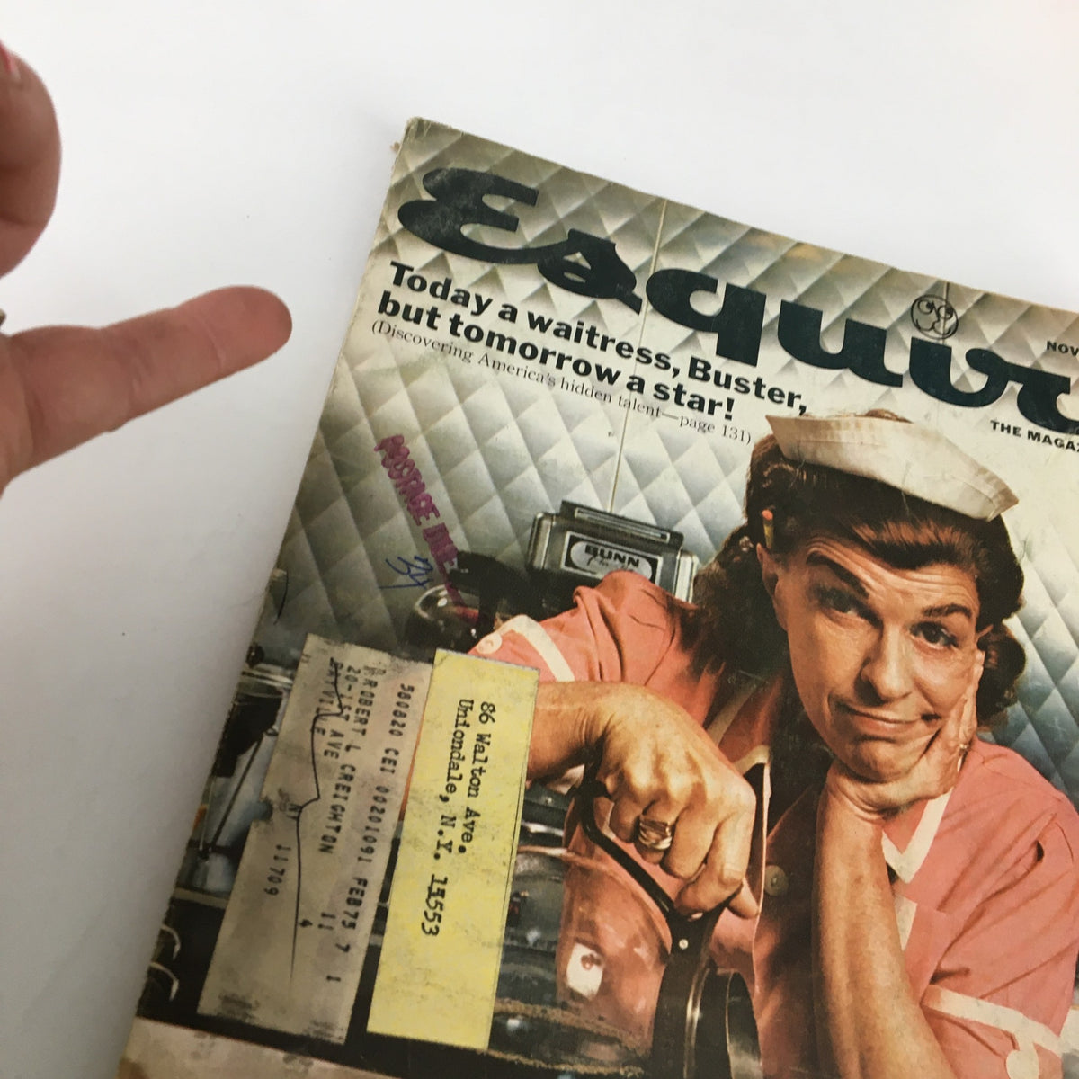 Close-up of the cover of VTG Esquire Magazine November 1974 with a waitress smiling while pouring coffee, highlighting the headline 'Today a waitress, Buster, but tomorrow a star!'