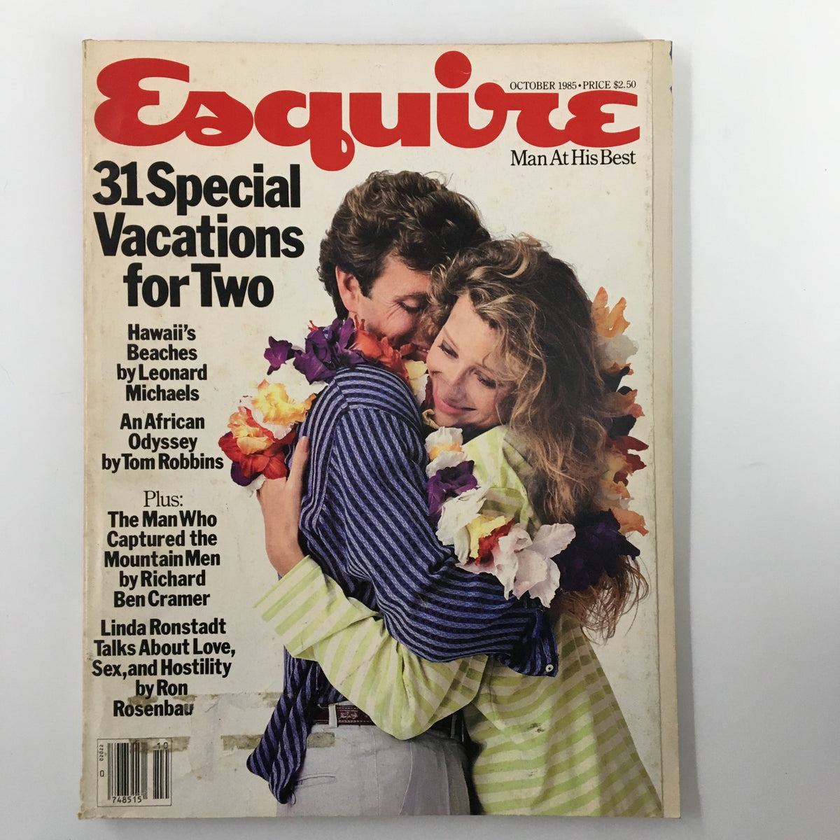 Cover of VTG Esquire Magazine October 1985, featuring the article 'The Man Who Captured the Mountain Men' alongside '31 Special Vacations for Two' and other topics. A couple is shown embracing with floral leis.