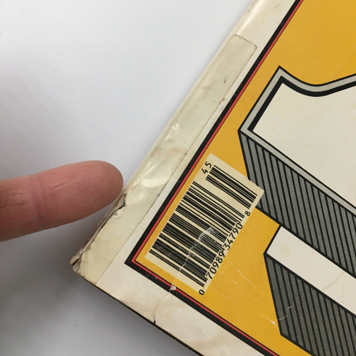Close-up view of the spine and barcode of the VTG Rolling Stone Magazine November 5, 1987, featuring Bob Dylan and Bruce Springsteen. The image shows minor wear typical of vintage magazines, highlighting the collectibility of this iconic music publication.