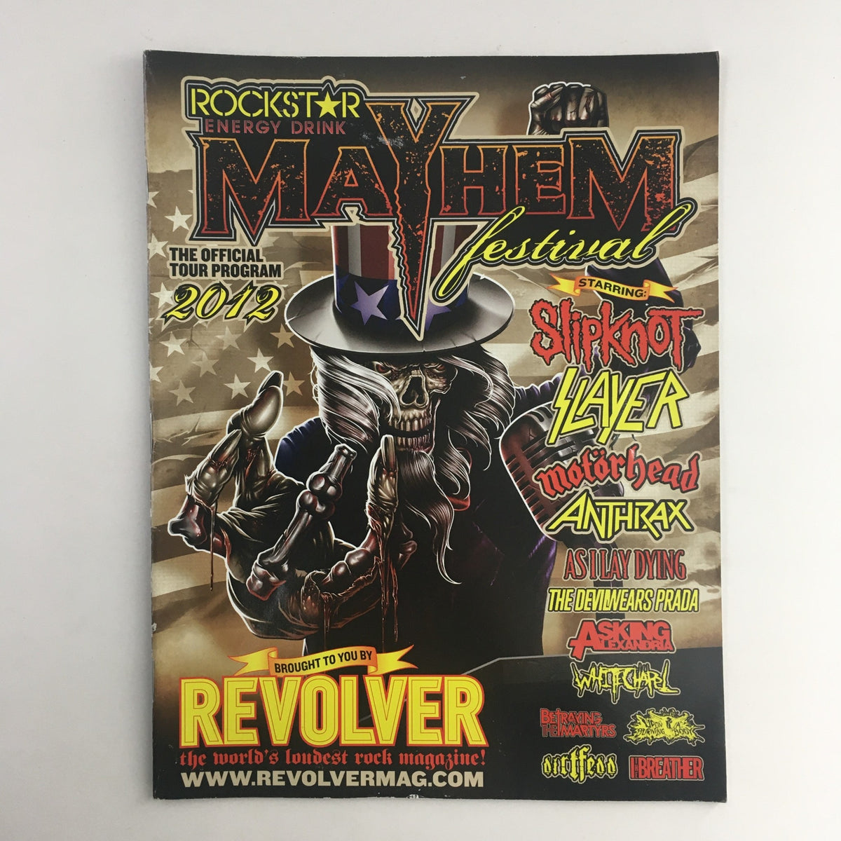 Revolver Presents 2012 Mayhem Festival The Official Tour Program lineup featuring iconic bands like Slipknot, Slayer, Motörhead, and more, depicted on the front cover of the collectible magazine.