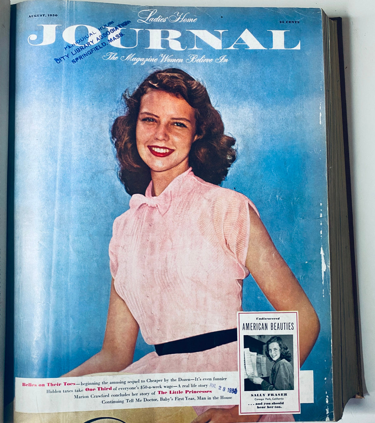 Cover of the August 1950 Ladies' Home Journal, featuring a smiling woman in a pink blouse, embodying 1950s fashion trends.