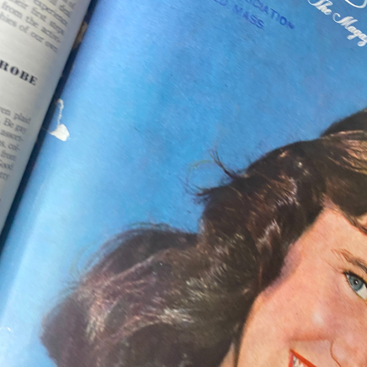 Close-up of the Ladies' Home Journal magazine cover from October 1950, showcasing the smiling woman's face alongside her kitten, capturing the essence of mid-century American culture.