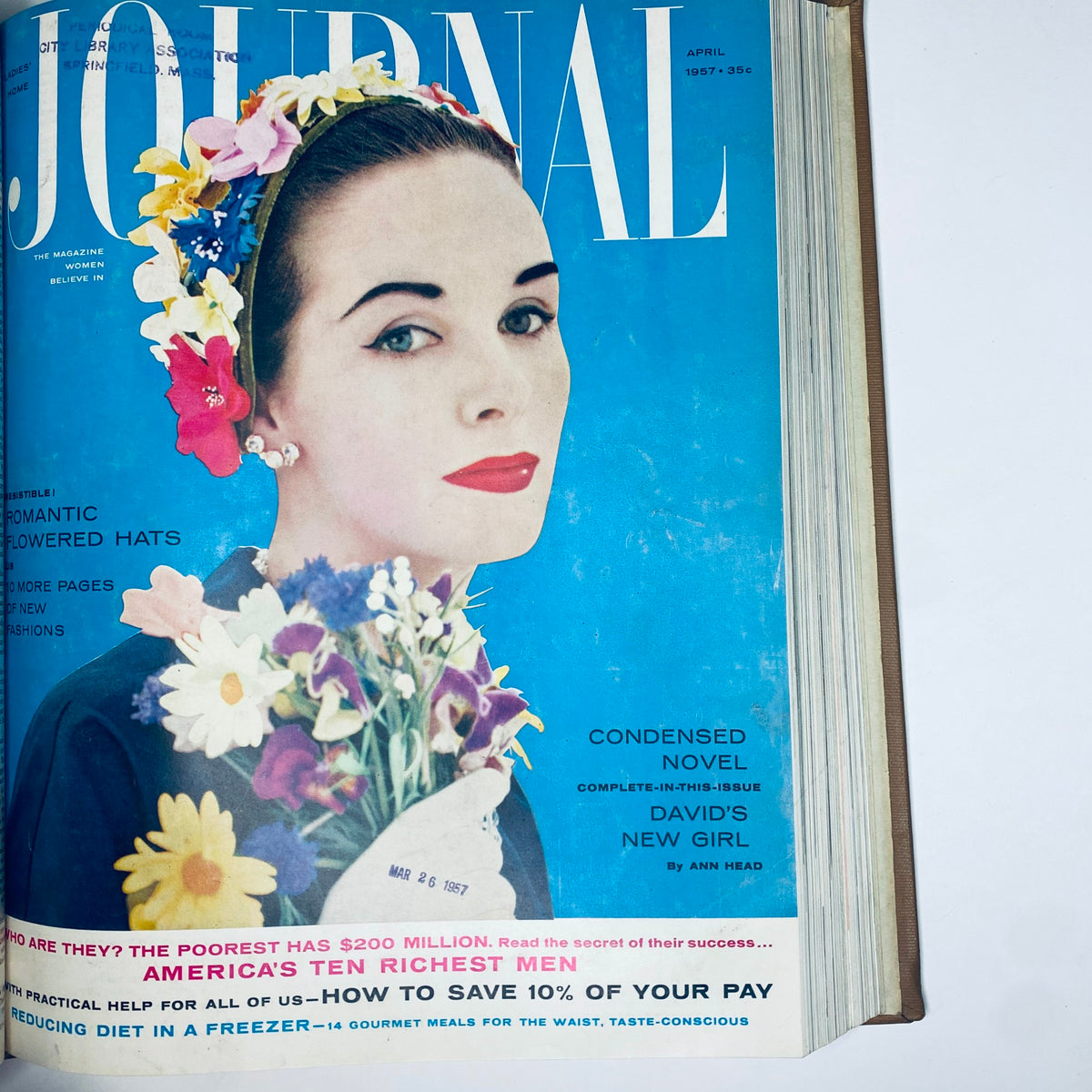 Ladies' Home Journal: April 1957. Cover showcases a woman adorned with flowers, emphasizing beauty, fashion, and financial advice.