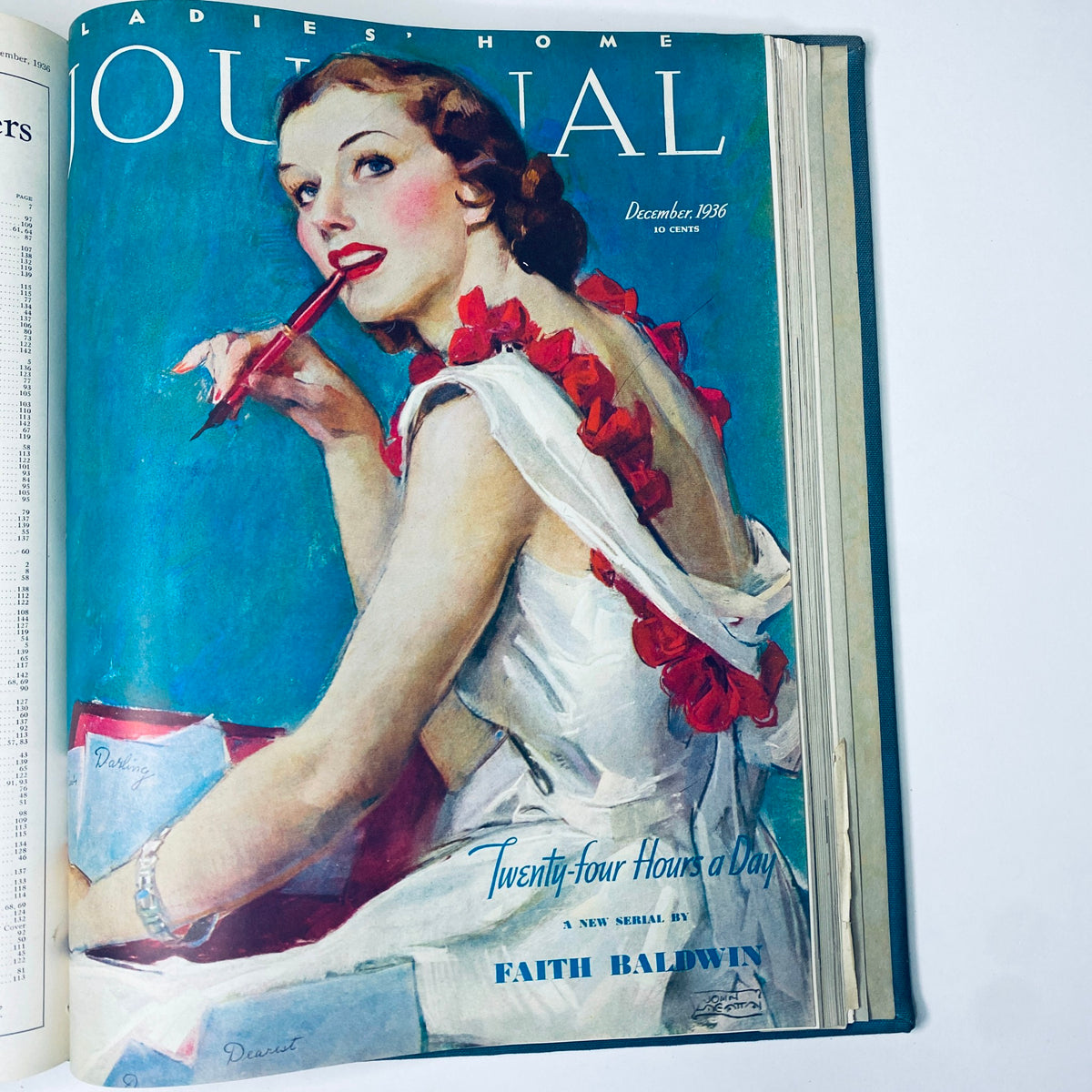 Cover page of the Ladies' Home Journal Bound Magazine 1936 showcasing a woman with a red flowered accessory, writing with a pen, featuring the title 'Ladies' Home Journal December 1936' and article 'Twenty-four Hours a Day' by Faith Baldwin.