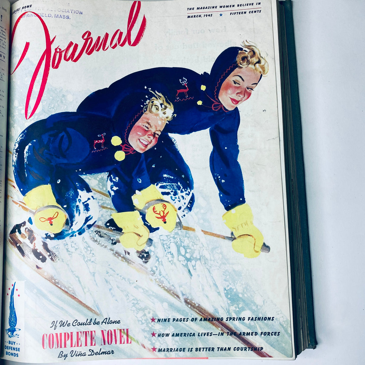 Ladies' Home Journal March 1942 magazine cover showcasing two children skiing, dressed in winter clothing with an emphasis on fashion of the era.