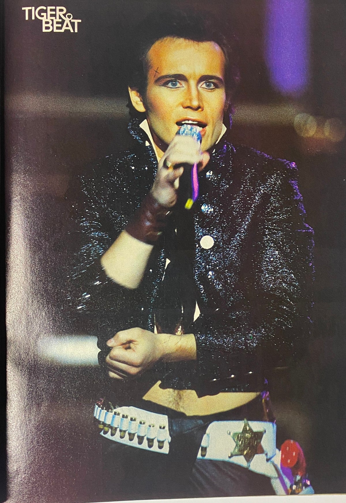Performance image of Rick Springfield in the March 1984 issue of Tiger Beat Magazine, showcasing the glam rock style of the early 80s.