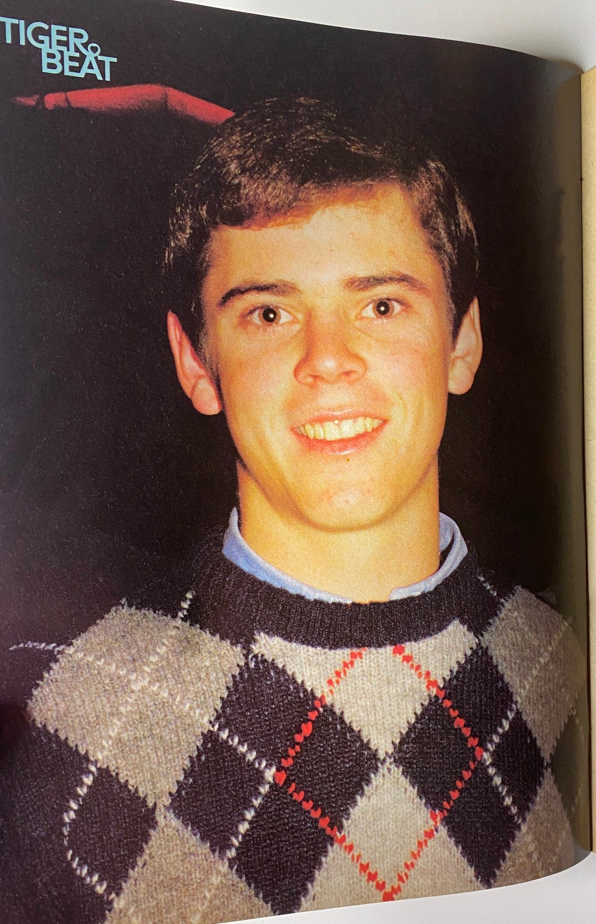 Portrait of a young man smiling, featured in the March 1984 issue of Tiger Beat Magazine, representing the teen celebrity culture of the era.