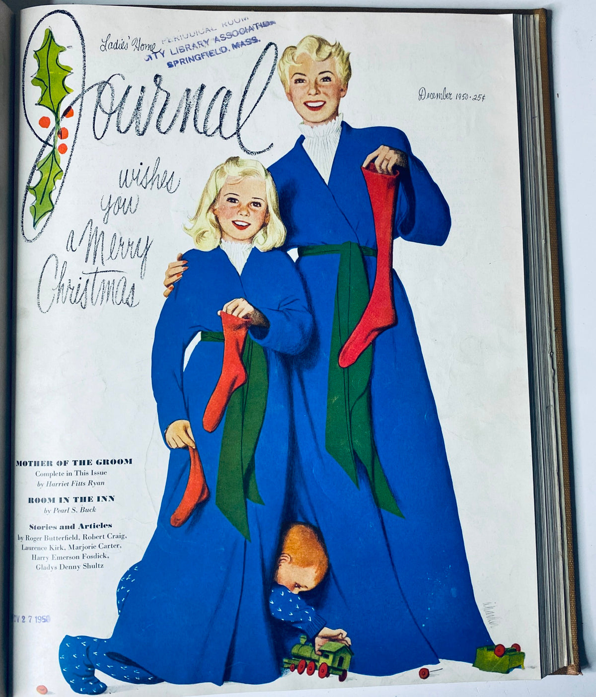 Ladies' Home Journal magazine cover from December 1950 wishing a Merry Christmas, illustrating two women in bright blue dresses holding stockings, embodying holiday cheer and 1950s style.