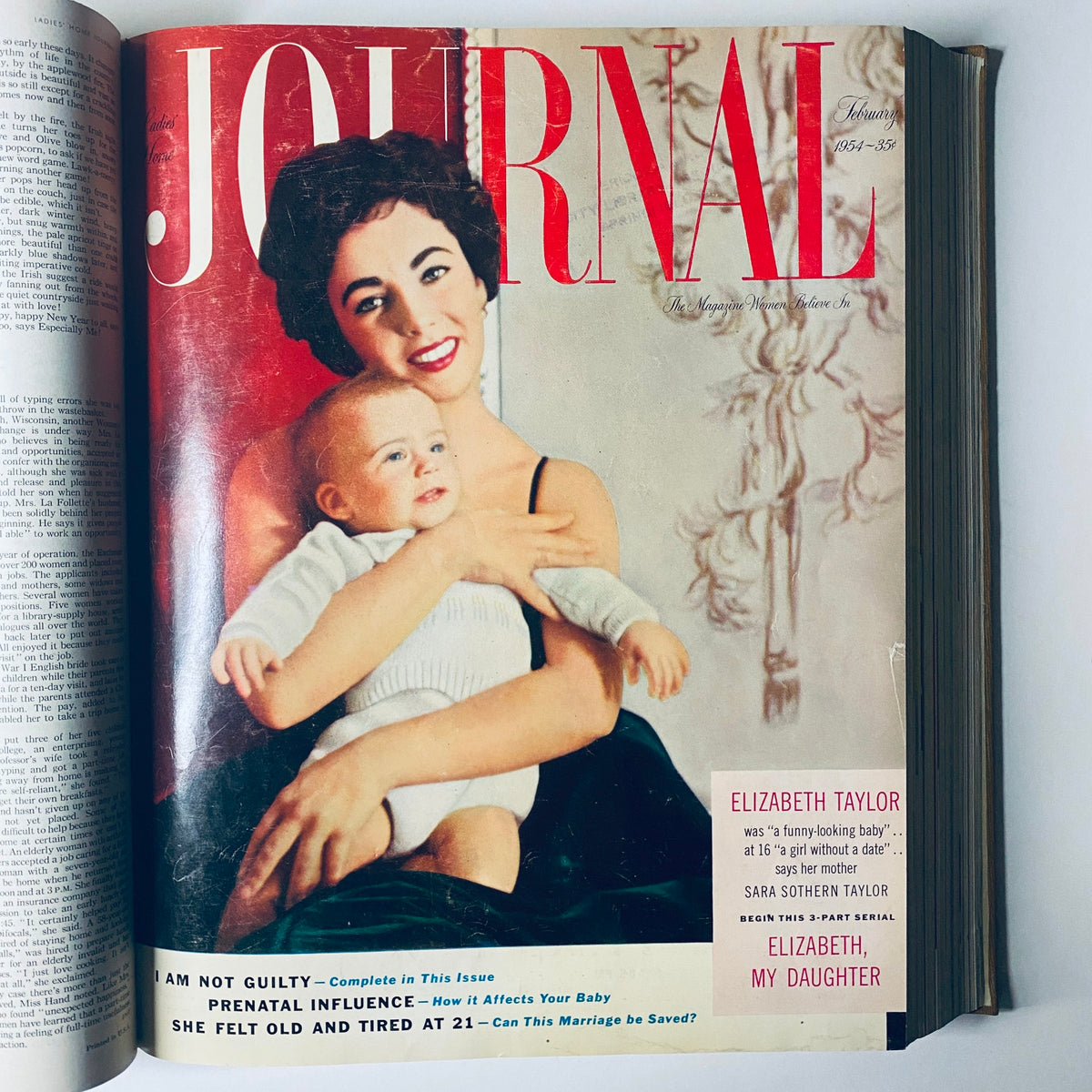 Ladies' Home Journal February 1954 cover with Elizabeth Taylor and her baby showcasing a vintage aesthetic.