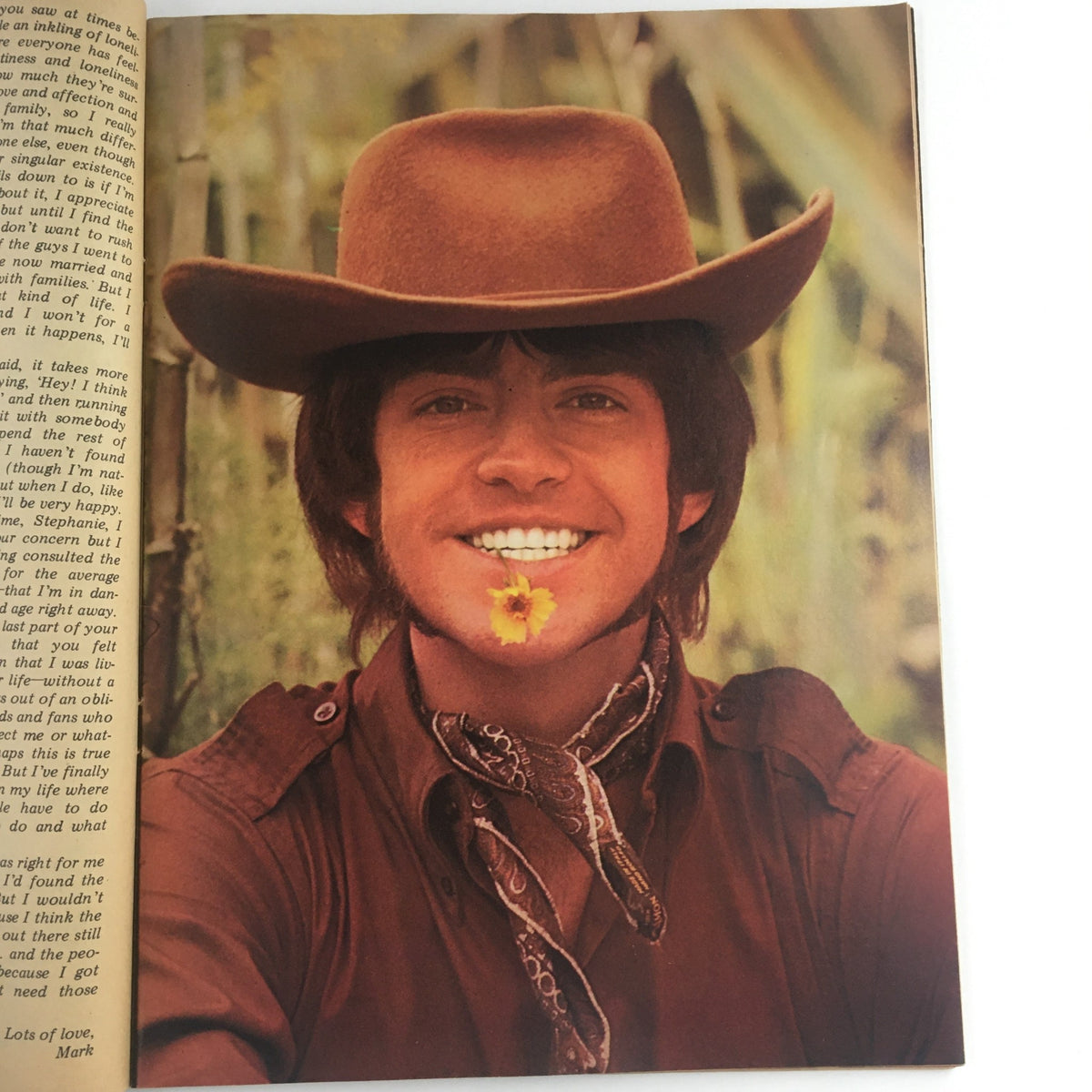 Vintage photo of a smiling young man wearing a cowboy hat and bandana, featured in Tiger Beat Magazine August 1969 with Bridget & Bobby Sherman.
