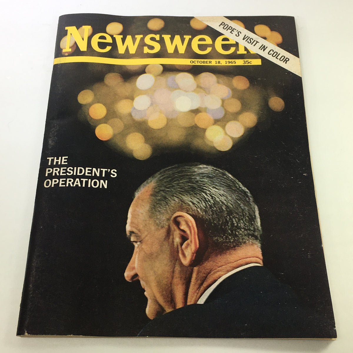 Cover of VTG Newsweek Magazine from October 18, 1965, featuring a profile of Lyndon B. Johnson with the headline 'The President's Operation.' Highlights of the vintage issue include colorful bokeh lights in the background and the note about the Pope's visit.